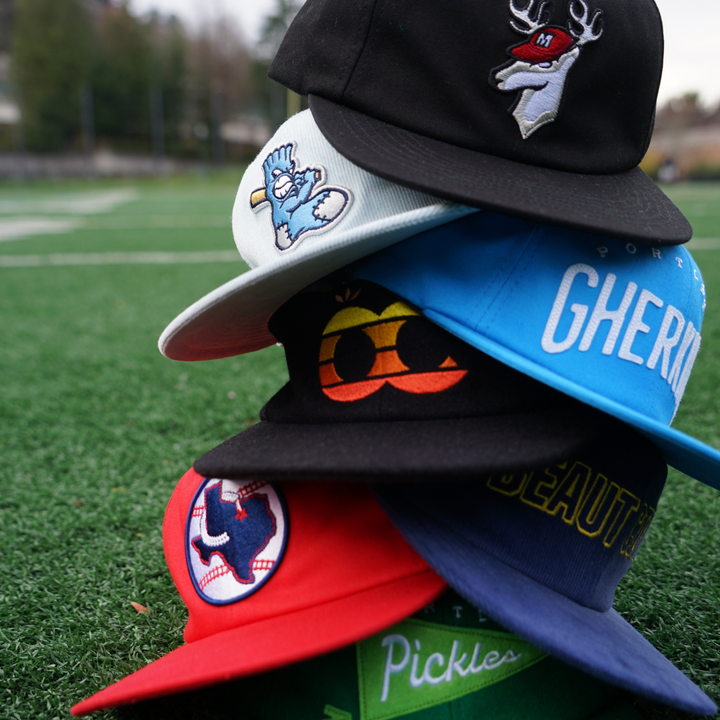 official league hats stacked on each other