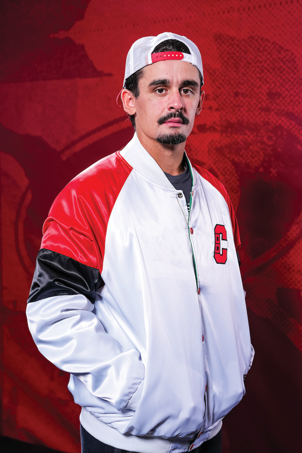 Seth Jarvis wearing the Carolina Hurricanes side of the reversible satin jacket