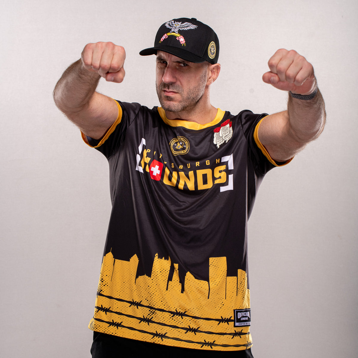 Claudio Castagnoli wearing his Pittsburgh Riverhounds collaboration jersey and hat