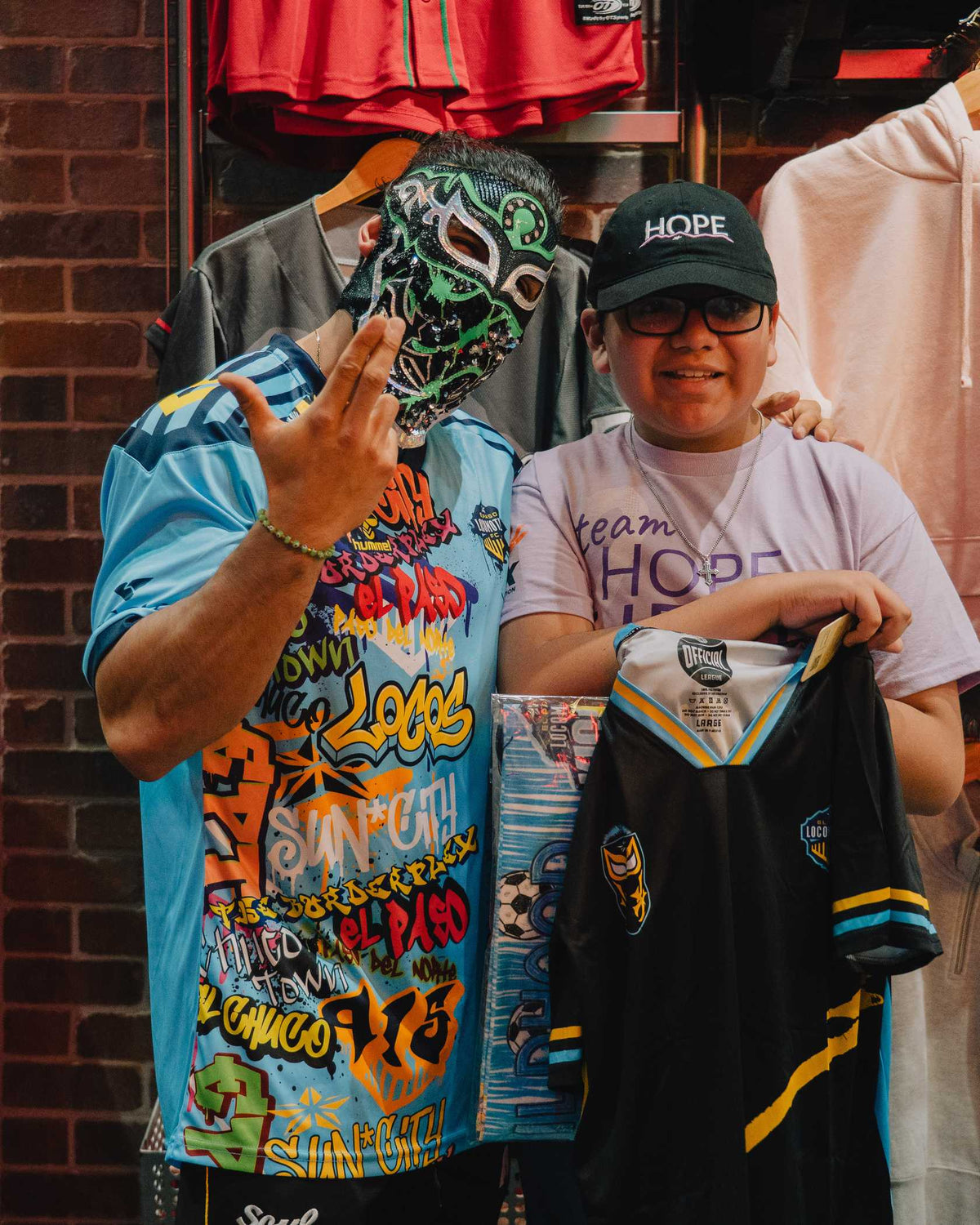 Bandido with a fan holding the Bandido’s Locos jersey at the game