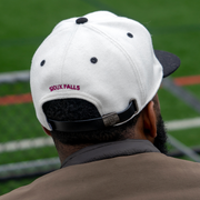 the back of a guy wearing sioux falls city fc hat 