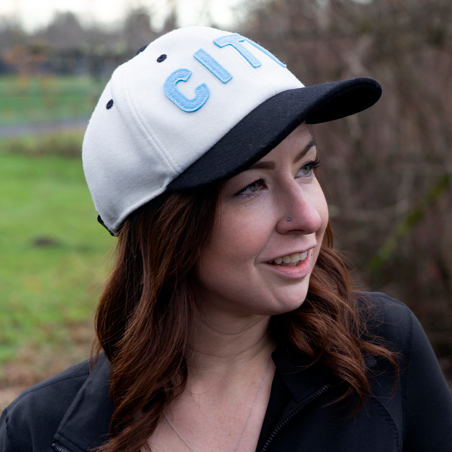 side view of a girl wearing a sioux falls city fc hat